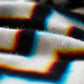 a close up of wrapped in light showing chromatic aberration around the black and white zig zags